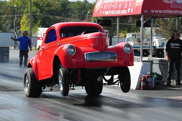 Red 1941 Willys Coupe Gasser wheelstand | Mac's Motor City Garage